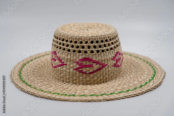 Fototapeta Antique straw hat made of natural materials isolated on white background