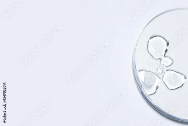 Fototapeta A crystal-clear droplet on white background with copy space for infographic to market place, serum toner cream swatch texture
