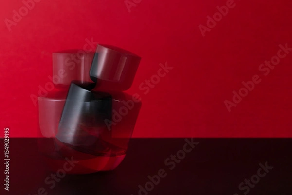 Fototapeta Bold red perfume bottle with motion blur, conveying luxury, sensuality, and movement. A visually striking concept in fragrance, glamour, and high-end beauty branding.