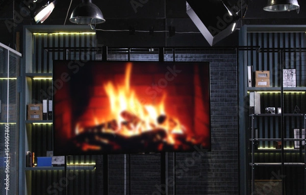 Obraz Studio Screen Monitor with Blurred Bonfire and Shelves with Thematic Items