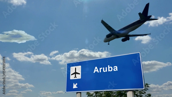 Fototapeta Plane landing in Aruba Caribbean airport with signboard