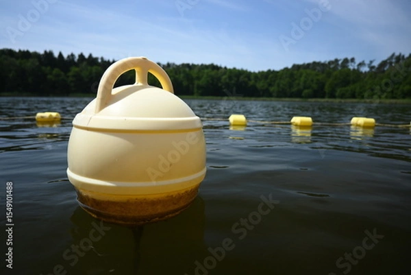 Fototapeta Buoys, warning floats at the bathing area. Safe recreation by the water.