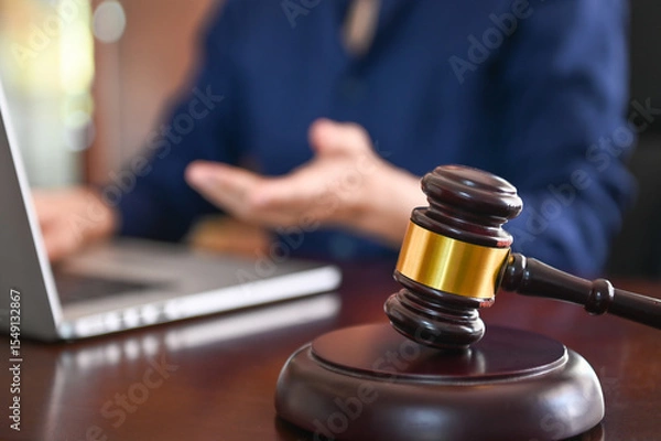 Fototapeta Technology, Information and Cyber ​​Laws Concept.  judge gavel and lawyer using computer in law firm.