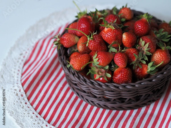Obraz Ripe red strawberry in basket on tablecloth