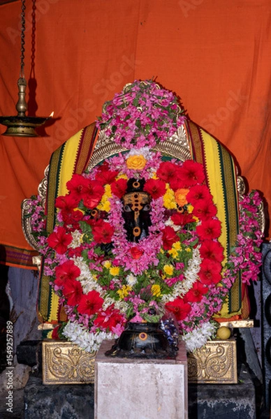 Obraz Decorated Hindu Deity Idol with Floral Garland and Ornate Background