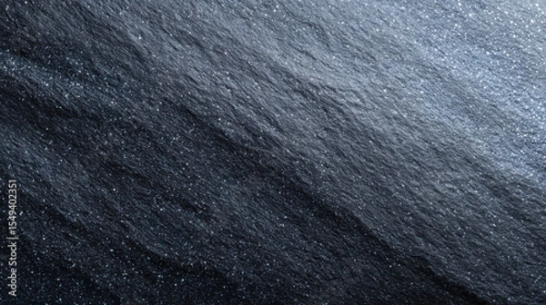 Fototapeta Elegant black stone background with rough, natural texture. dark slate surface has subtle shimmer from mineral flecks, creating dramatic and solid backdrop