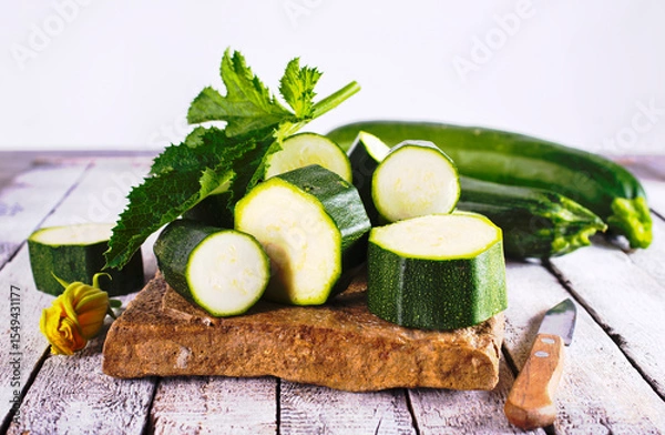 Obraz Slicing zucchini on a cutting board. Ripe zucchini. Top view, horizontal.