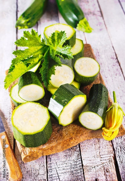 Obraz Slicing zucchini on a cutting board. Ripe zucchini. Top view, horizontal.