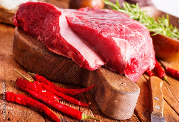 Obraz Raw meat on cutting board, with herbs, spices on cooking table top view copy space