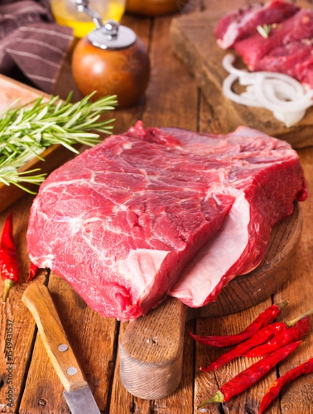 Obraz Raw meat on cutting board, with herbs, spices on cooking table top view copy space