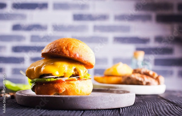 Obraz Close up cheese burger on wooden background.