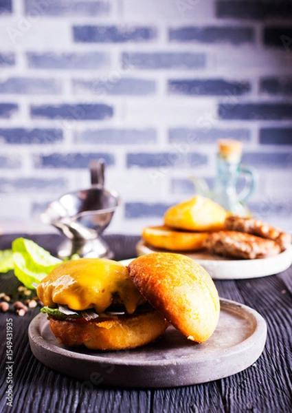 Obraz Close up cheese burger on wooden background.