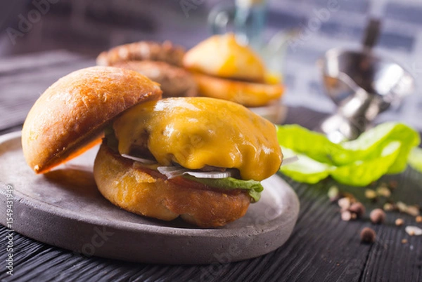 Obraz Close up cheese burger on wooden background.