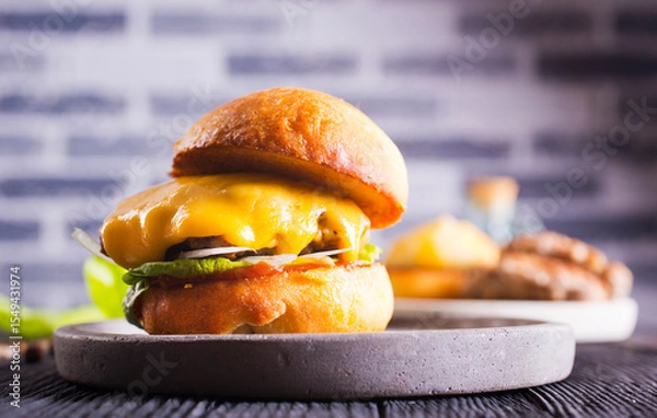 Obraz Close up cheese burger on wooden background.