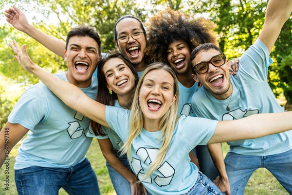 Fototapeta Multi ethnic group of volunteers cleaning up a forest together - Happy team of environmental activists smiling at camera outdoors - Environmental protection and non profits organization concept