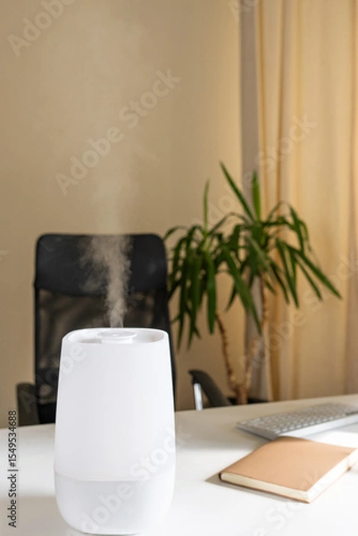 Fototapeta Modern air freshener humidifier emitting steam in a serene office environment for improved air quality and comfort