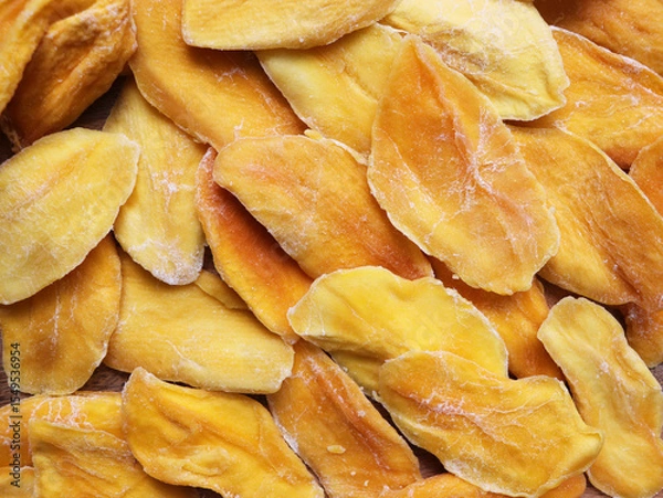 Fototapeta Dried mango on the market. Delicious sweet slices of dried mango background.
