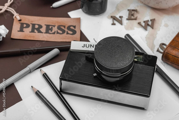 Obraz Creative flat lay with vintage camera, press tag, ink bottle, spilled coffee, and messy papers
