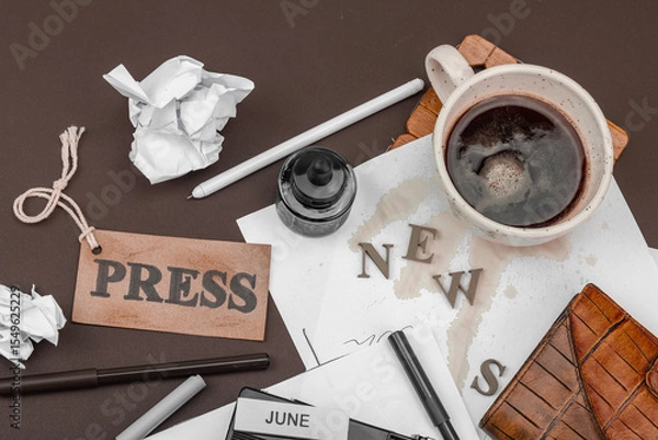 Obraz Creative flat lay with vintage camera, press tag, ink bottle, spilled coffee, and messy papers