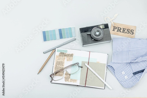 Obraz Flat lay of retro journalist essentials on blue background: camera, press badge, notebook