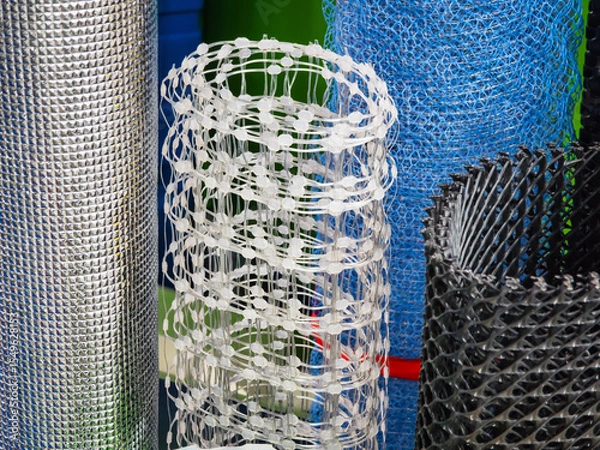 Obraz Various types of mesh rolls displayed in a hardware store during daylight hours