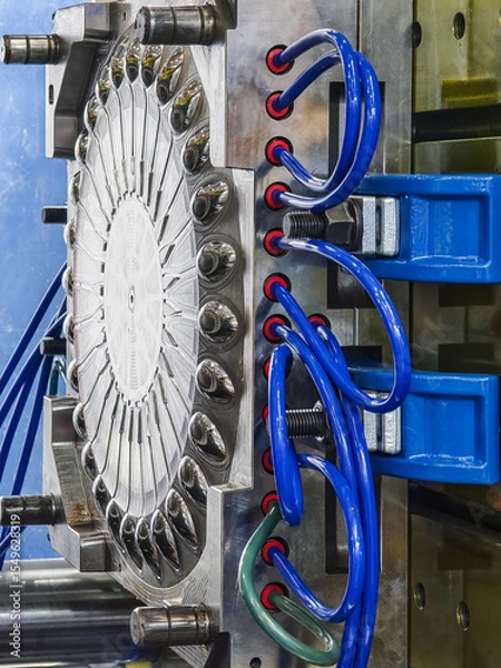Obraz Plastic press machinery used in industrial manufacturing processes at a factory facility for producing various plastic components