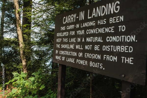 Fototapeta Sign explaining why Hemlock Lake in northern Wisconsin has a carry-in only boat launch, and the benefits to the lakeshore environment, near Woodruff, Wisconsin