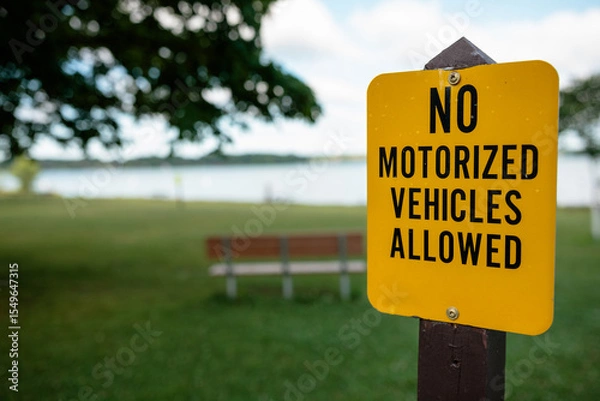 Fototapeta A sign stating no motorized vehicles allowed in the picnic and beach area within Pike Lake Unit, Kettle Moraine State Forest, Hartford, Wisconsin