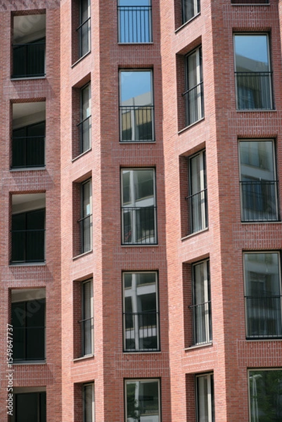 Fototapeta façade d'un immeuble moderne en briques avec fenêtres
