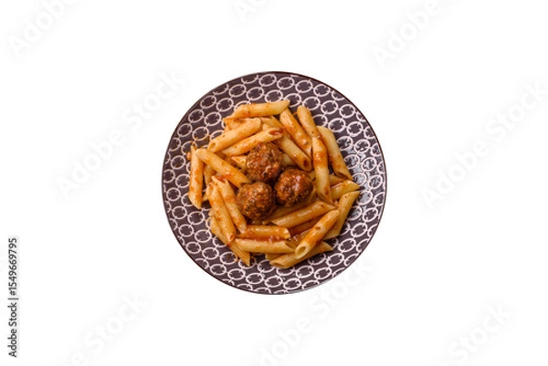 Obraz Penne pasta with meatballs in tomato sauce with salt and spices. Italian food penne pasta