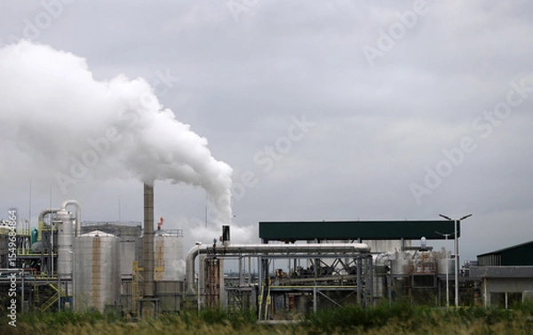 Fototapeta 
Factory generating industrial pollution by emitting smoke and smog