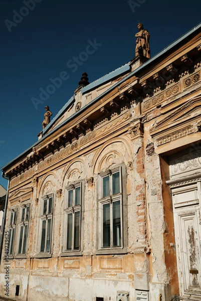 Obraz A richly decorated historic building with statues on the roof in Vrsac, Serbia