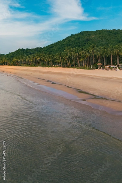 Obraz Stunning aerial view of Nacpan Beach’s winding shore, vibrant tropical greenery, and sparkling clear sea in El Nido, Palawan, Philippines