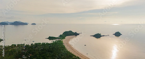 Obraz Stunning aerial view of Nacpan Beach’s winding shore, vibrant tropical greenery, and sparkling clear sea in El Nido, Palawan, Philippines