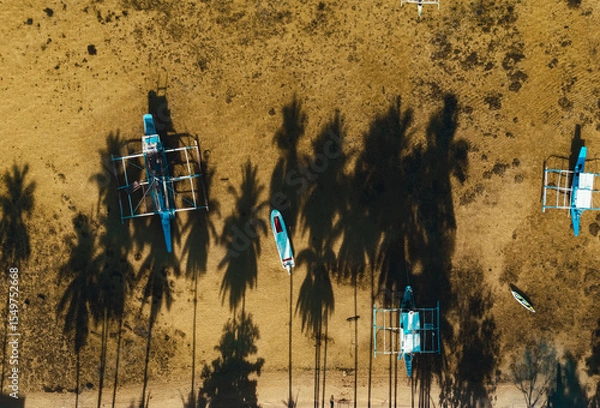 Obraz Top Down Drone View of Dozens of Traditional Filipino Outrigger Boats Floating in Clear Blue Water off Corong Corong Beach, El Nido, Philippines.