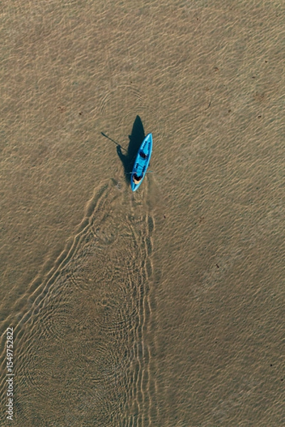 Obraz Top Down Drone View of man kayaking in Clear Blue Water off Corong Corong Beach, El Nido, Philippines.