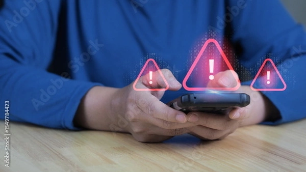 Fototapeta A person is using a smartphone with virtual error 404 alerts on the screen, representing cyber attacks, security warnings, and the dangers of network failures and spam in digital technology.