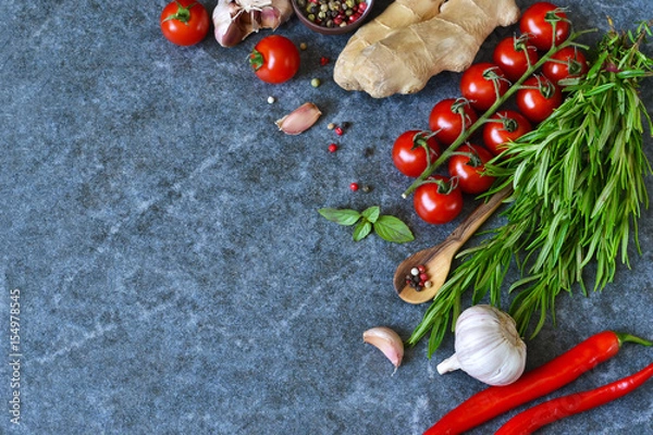Fototapeta Food background with different ingredients on a marble background. Cherry tomatoes, rosemary, garlic, pepper, lime. Top view.