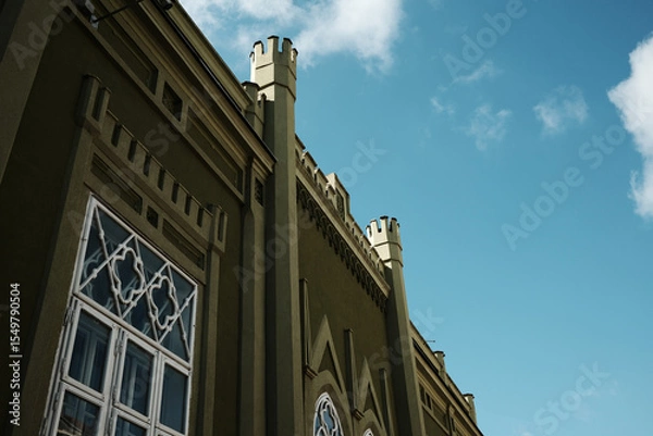 Obraz Green building with fortress-like towers and unique window patterns in Vrsac, Serbia.