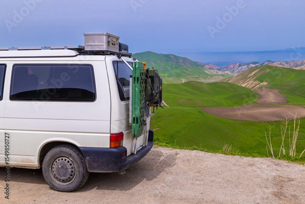 Obraz Travel Van carrying equipment on roof rack in mountainous area