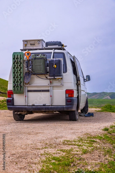 Obraz Van carrying equipment in serene rural landscape during daytime