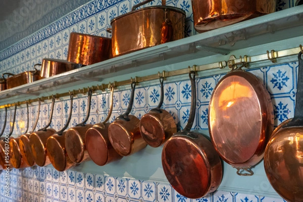 Obraz Copper pans lined up on a kitchen wall
