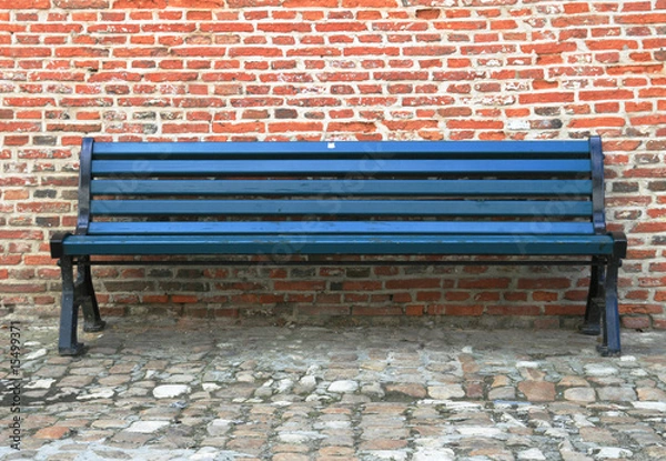 Fototapeta Bench against a brick wall
