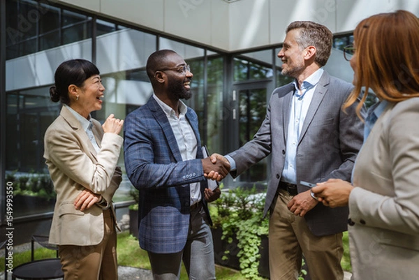 Obraz Happy black businessman and caucasian businessman shake hands