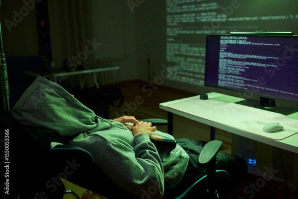 Fototapeta Cybersecurity Analyst Engaged in Writing Code Within a Dimly Lit Environment for Efficiency