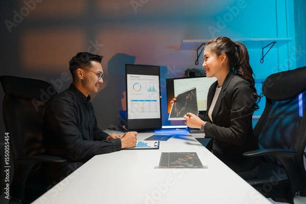 Obraz Business Professionals Discussing Data Charts in Office