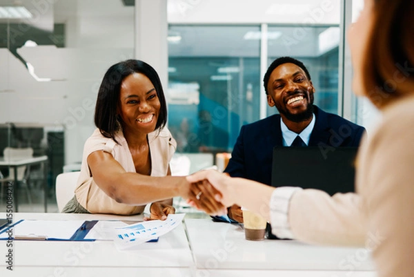 Obraz Business partners shaking hands after successful meeting in modern office