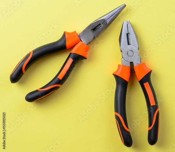 Fototapeta Flatnose and longnose pliers arranged on yellow background for repair and DIY theme