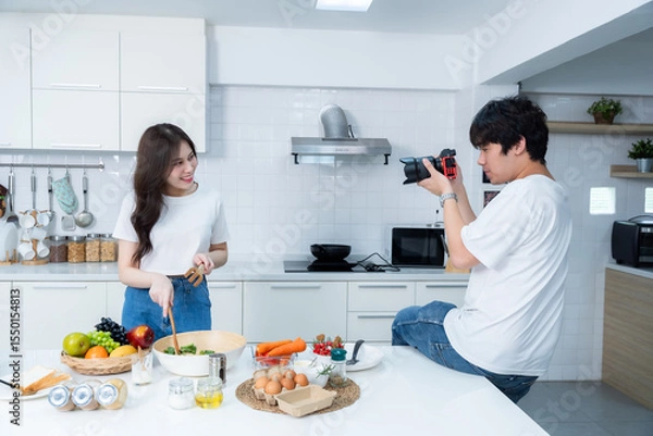 Obraz Happy portrait of loving young asian of having fun standing Take a photo after enjoy cook cooking with vegetables, meat, bread while standing on a kitchen Condo life or home