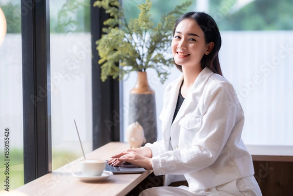 Obraz Asian freelance people business female talking making using casual working with laptop computer and coffee at home in the living room indoors artificial rose bouquet of red and pink roses rose vase